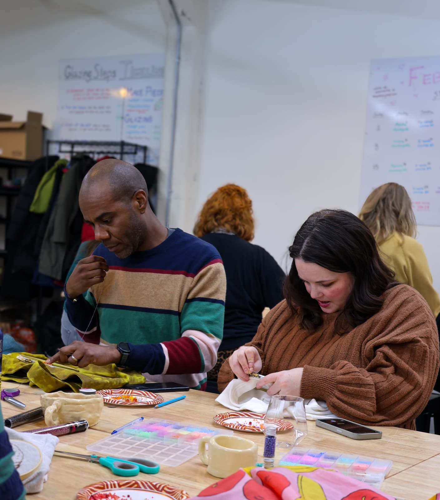 Friends laughing while crafting together at a private workshop