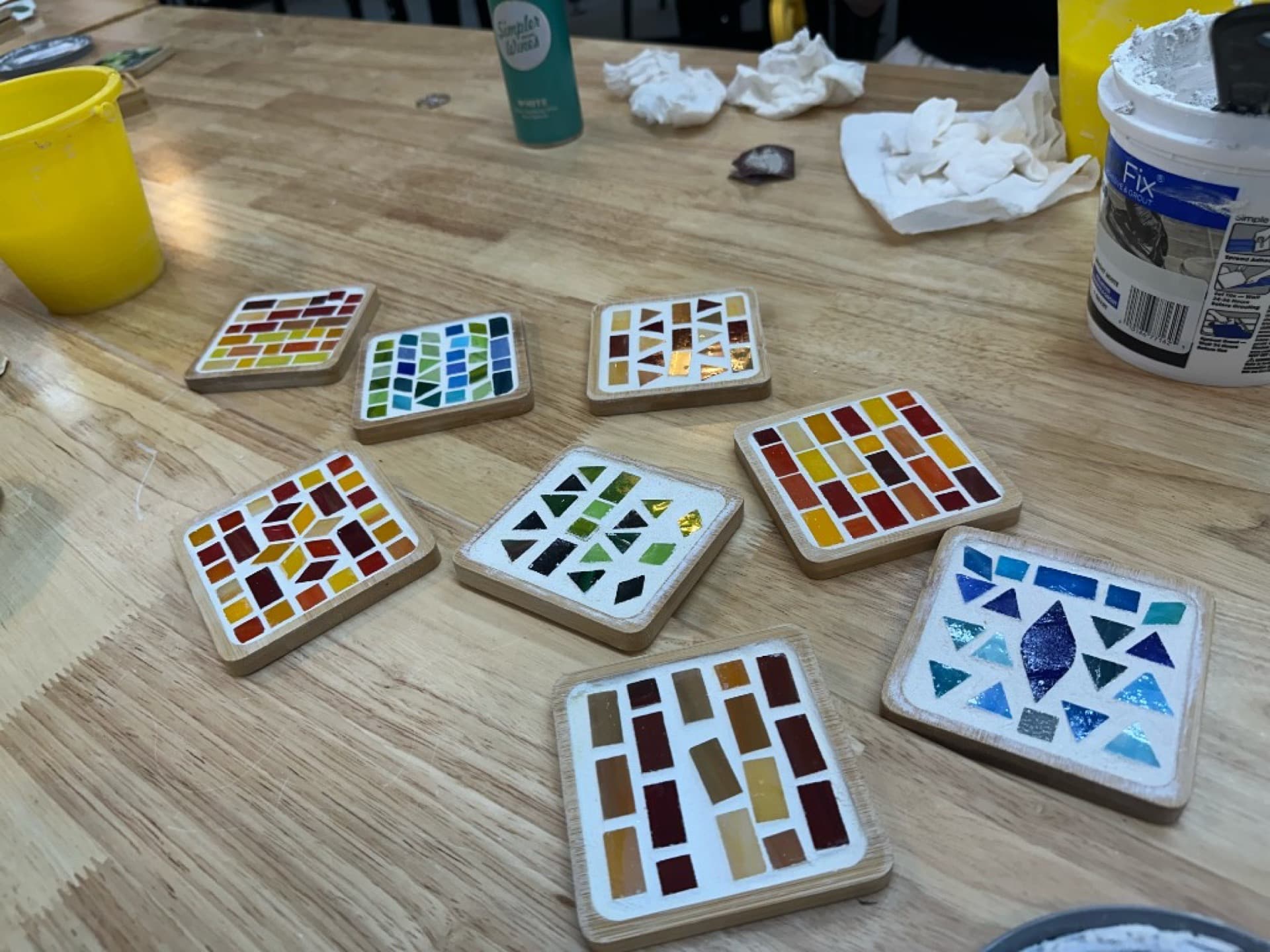 Colorful handmade mosaic coasters from a workshop session